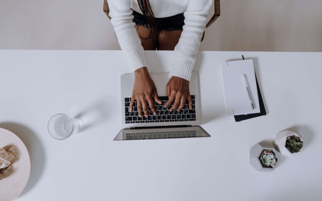 woman writing on laptop