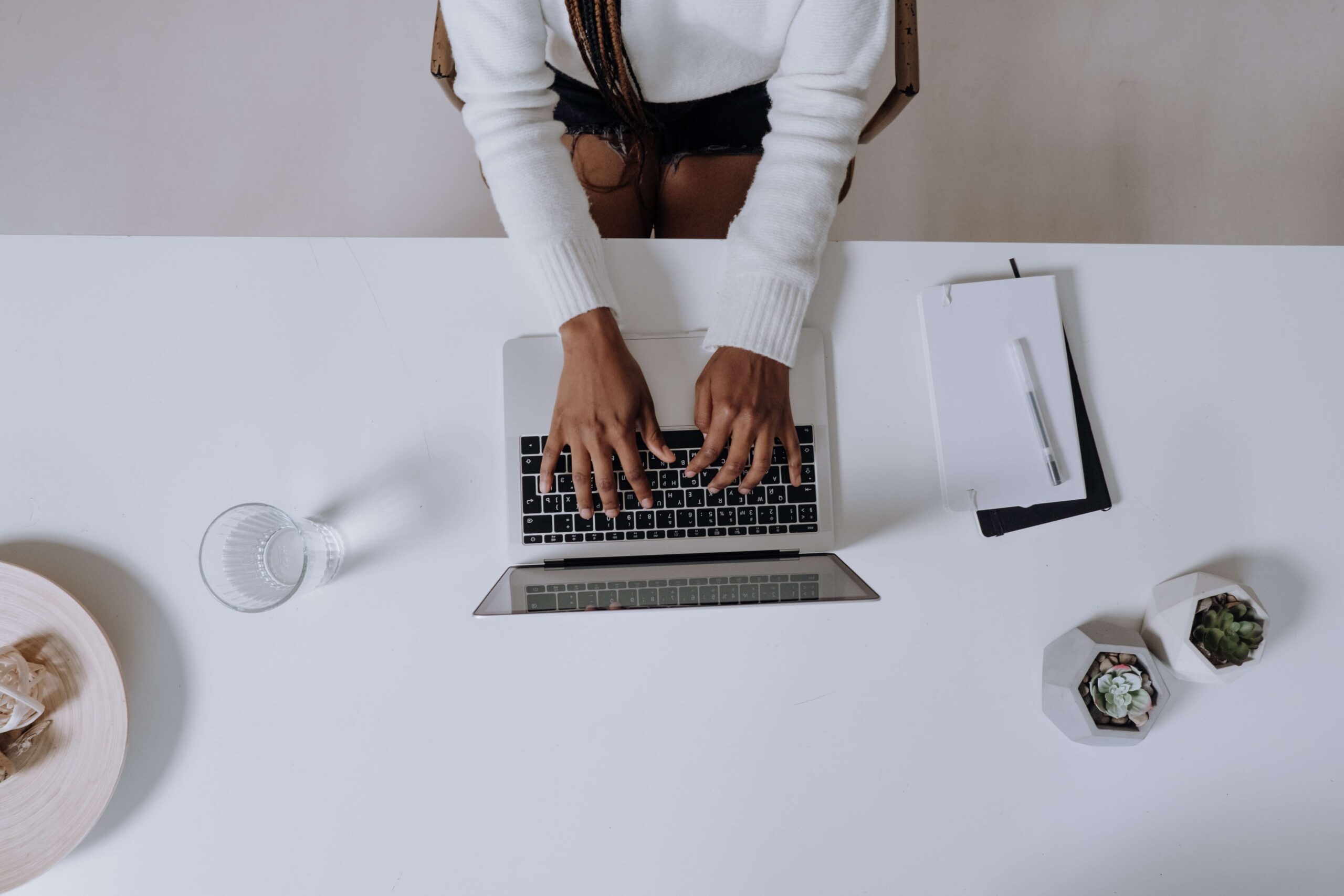 woman writing on laptop
