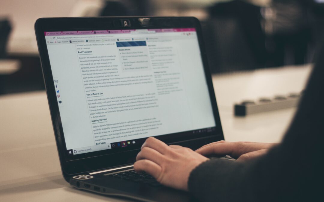 typing on a website on a laptop