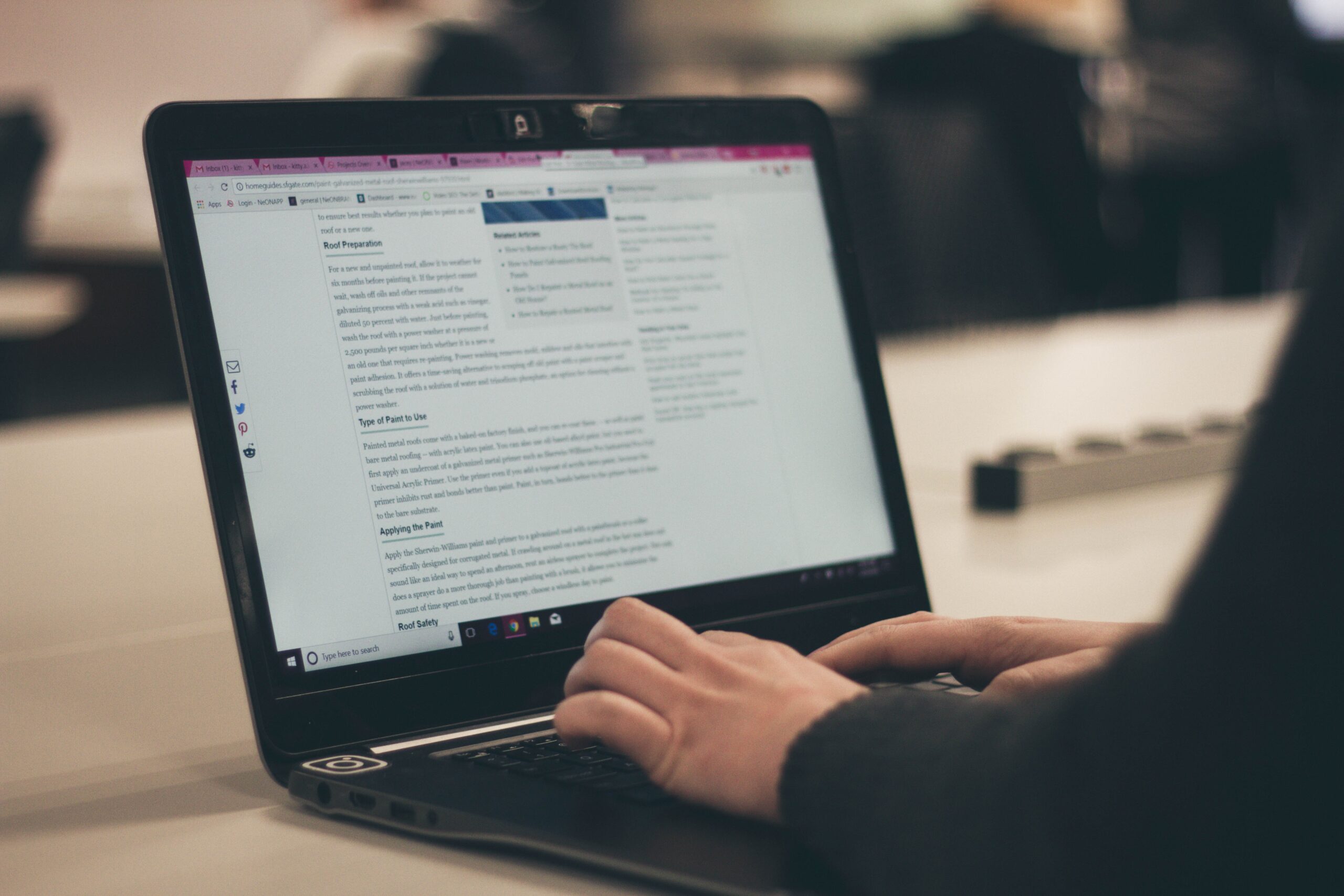 typing on a website on a laptop